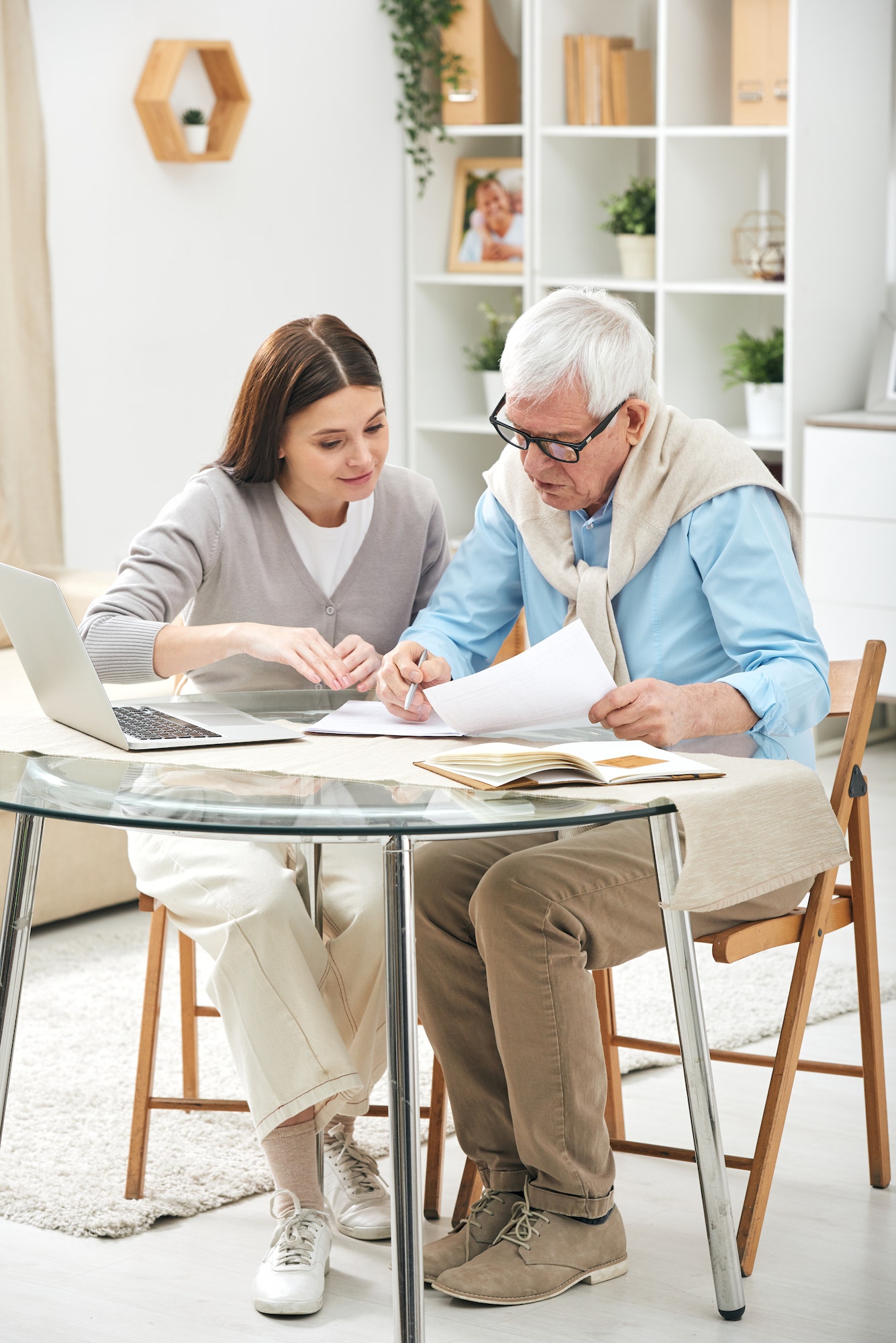Insurance agent assisting senior to fill papers